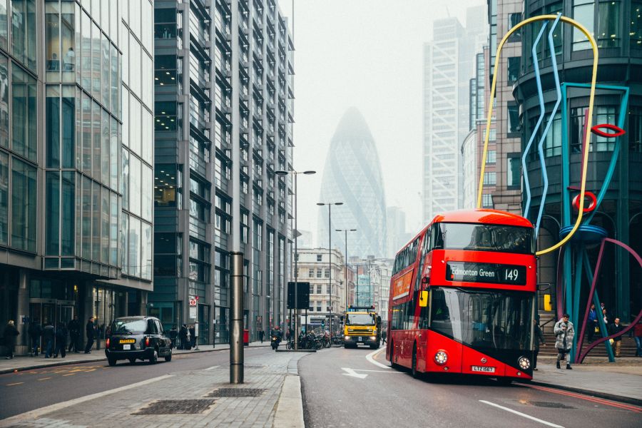 London street scene with a red double-decker bus and the Gherkin in the background